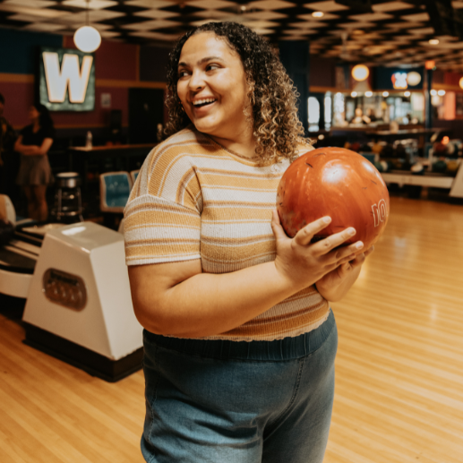 Woman going ten pin bowling